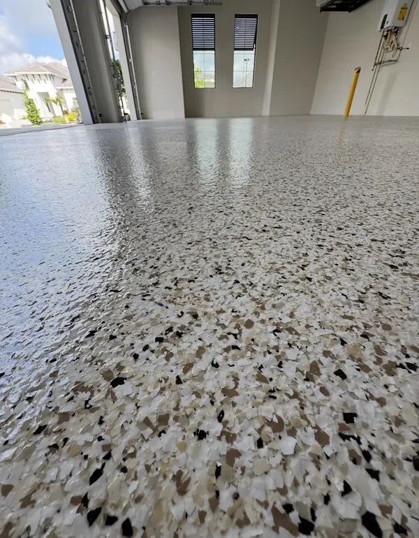 Tan and black flake epoxy garage floor