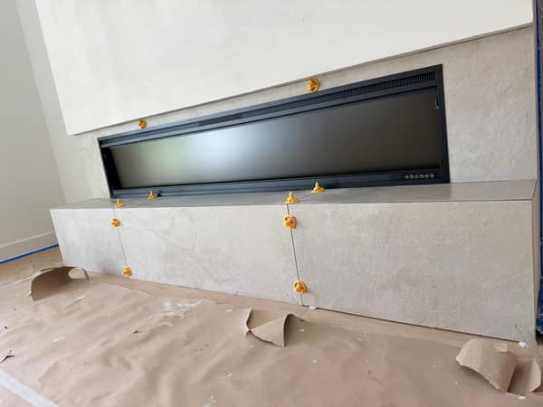 Installing large-format tile on fireplace wall