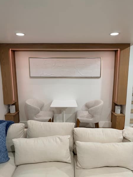 Backlit wood feature alcove with built-in cabinets