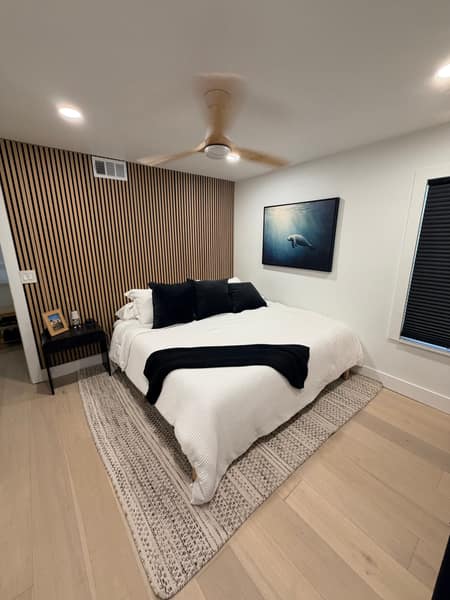 Wood slat accent wall behind bed