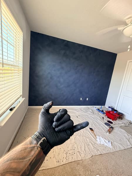 Navy painted accent wall in a bedroom