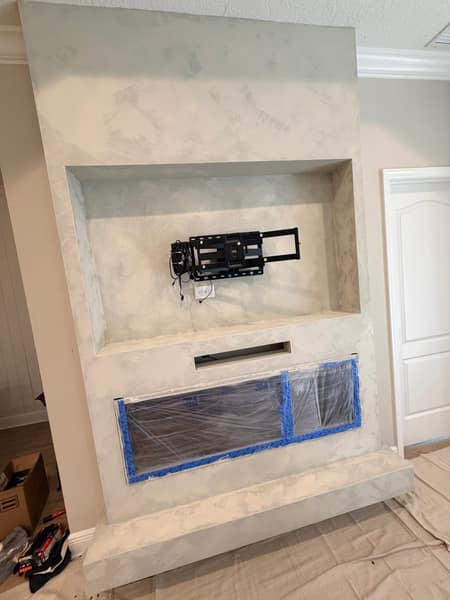 Venetian plaster application on fireplace media wall