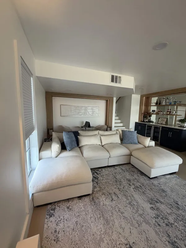 Remodeled family room with built-in wet bar and trimmed feature wall
