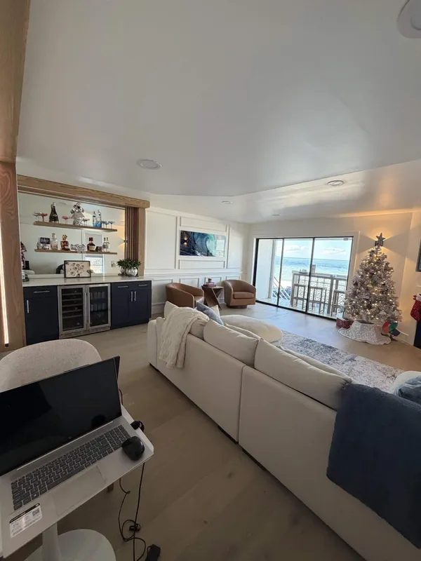 Oceanfront living room remodel with custom wet bar and wainscoting