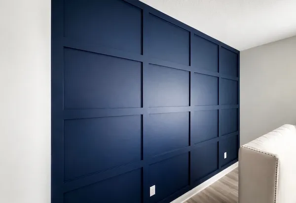 Navy blue grid-panel board-and-batten accent wall in a living room